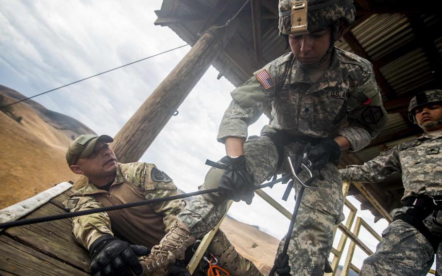 A U.S. Army Reserve combat engineer from the 374th Engineer Company checks his rope before rappelling a 100-foot tower, July 19, 2015, during a two-week field exercise known as a Sapper Leader Course Prerequisite Training at Camp San Luis Obispo Military Installation, Calif.