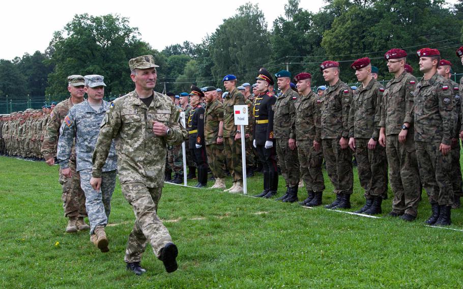 Ukrainian and U.S. officers review troops in formation during a ceremony marking the start of Rapid Trident 2015, a long-standing cooperative training exercise focused on stability and peacekeeping operations, in Yavoriv, Ukraine, July 20, 2015. More than 1,800 personnel from 18 different nations are participating in the exercise.