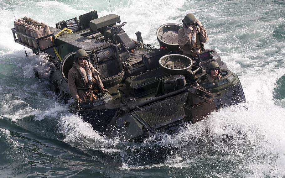 Marines with Amphibious Assault Platoon, Company E, Battalion Landing Team 2/6, load the unit's amphibious assault vehicles aboard the USS Oak Hill (LSD-51) during the 26th Marine Expeditionary Unit's Composite Training Exercise, July 19, 2015.
