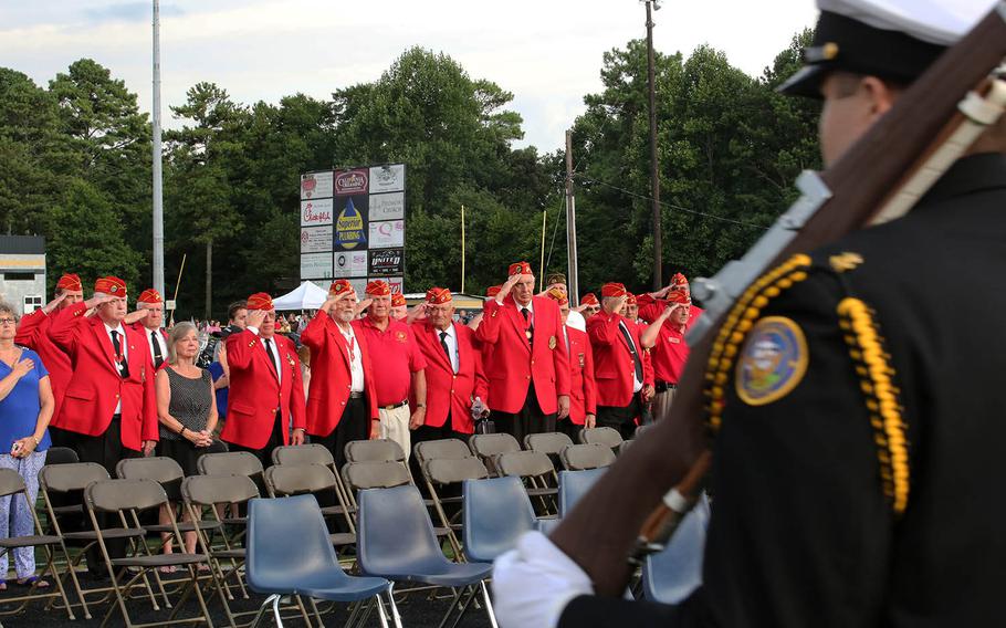 Veterans with the Marine Corps League of Woodstock, Ga., stand and salute the colors as they pass by during Lance Cpl. Squire Wells' memorial at Sprayberry High School in Marietta, Ga., July 21, 2015. Wells is one of five servicemembers to be killed when a gunman entered the Naval Operational Support Center and Marine Corps Reserve Center in Chattanooga, Tenn. on July 16, 2015.