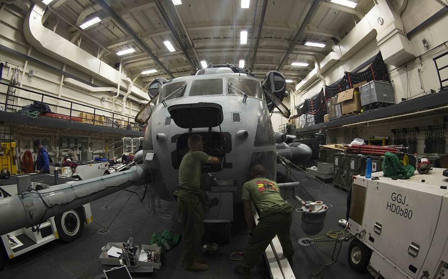 CH-53E avionics technicians with the Marine Medium Tiltrotor Squadron 162, 26th Marine Expeditionary Unit, conduct preventive maintenance on a CH-53E Super Stallion aboard the USS Arlington in the Atlantic Ocean, July 21, 2015.