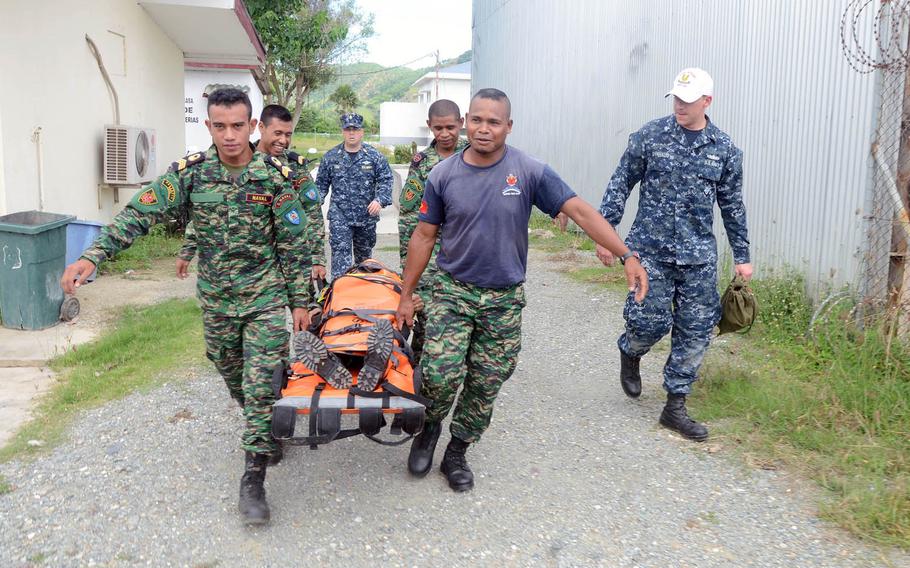 Sailors assigned to the guided-missile destroyer USS Kidd and members of East Timor's Defense Force conduct stretcher bearer training during a medical skills exchange during last year's Cooperation Afloat Readiness and Training (CARAT). CARAT is a series of annual bilateral exercises conducted with Bangladesh, Brunei, Cambodia, Indonesia, Malaysia, Philippines, Singapore, Thailand, and Timor Leste.