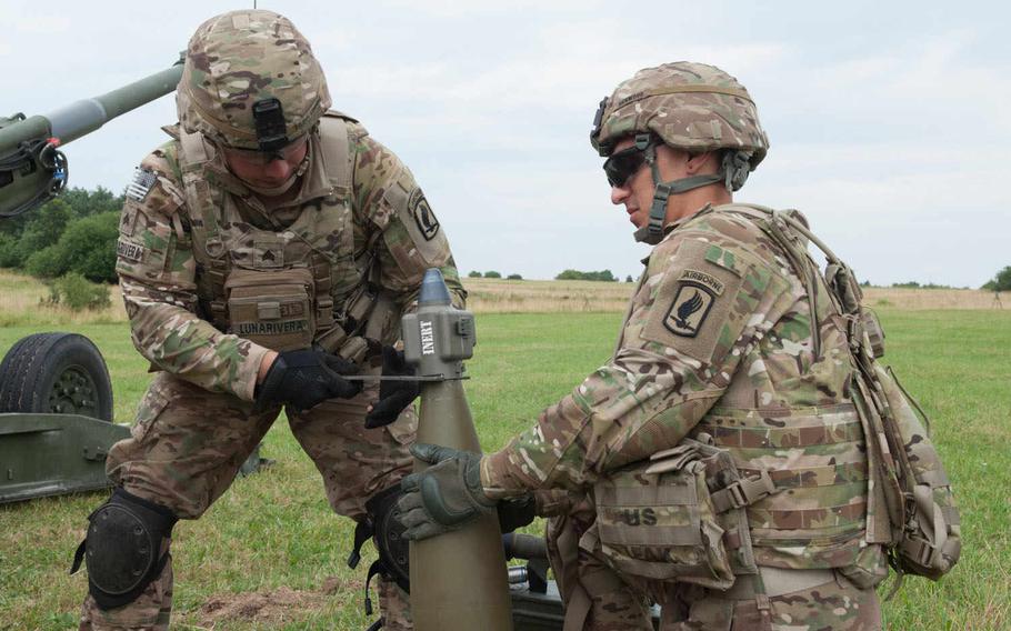 Before firing live M1156 Precision Guidance Kit fuse enhanced shells, these artillerymen from the 173rd Airborne Brigade Combat Team run through dry fire exercises at one of the artillery ranges at Vilseck, Germany, July 23, 2015.