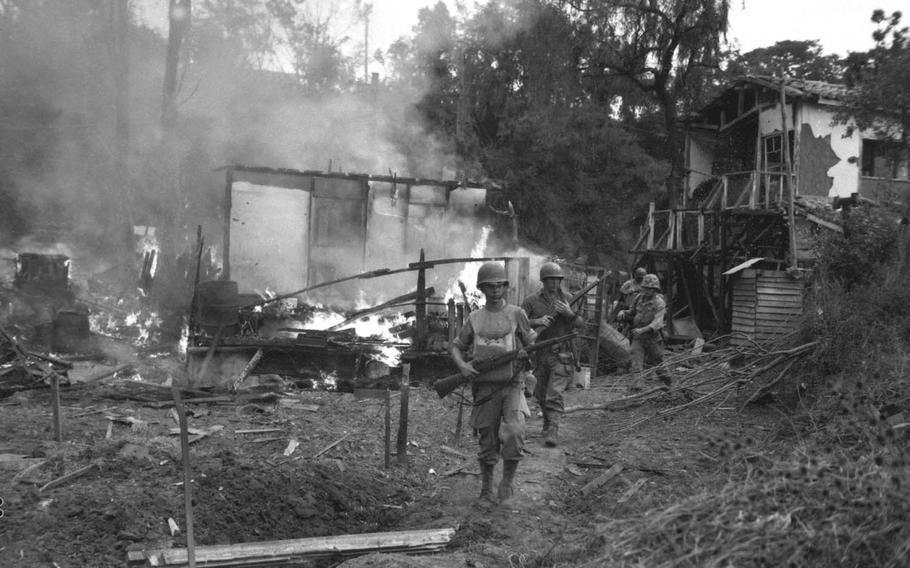 Leathernecks lead a patrol between destroyed buildings during a "mop up" of Wolmi Island, Sept. 15, 1950. Some 400 North Korean troops invaded Wolmi, and the U.S believed an attack on the island was necessary in advance of a planned amphibious assault on Incheon.