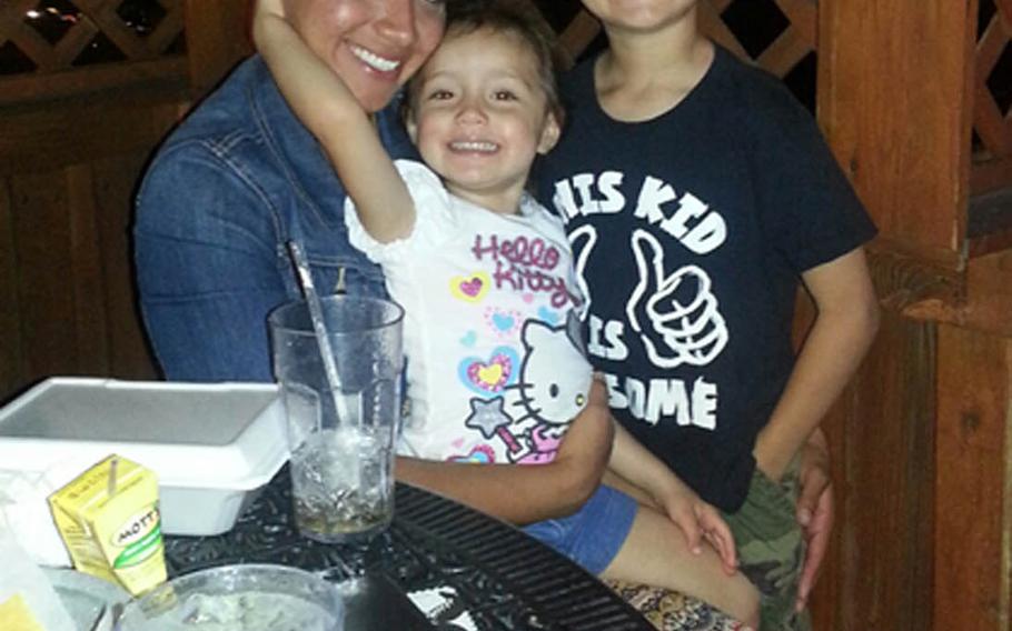 Marine Sgt. Jennifer Suarez, posing with her children, beat brain cancer and returned to active duty in the Marine Corps.