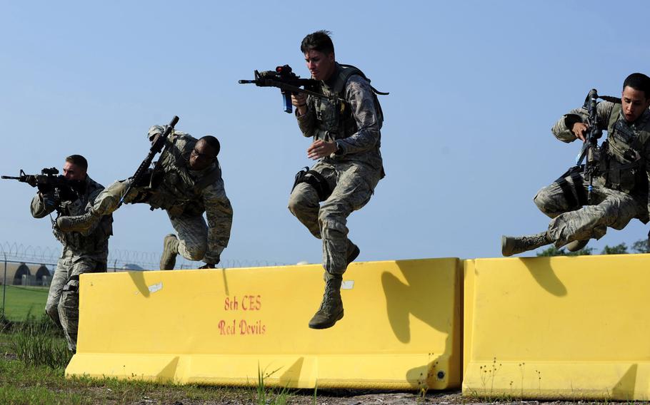 Airmen from the 8th Security Forces Squadron participate in a shoot, move and communicate drill during a three-day combat readiness training exercise at Kunsan Air Base, South Korea, on Monday, Aug. 3, 2015.