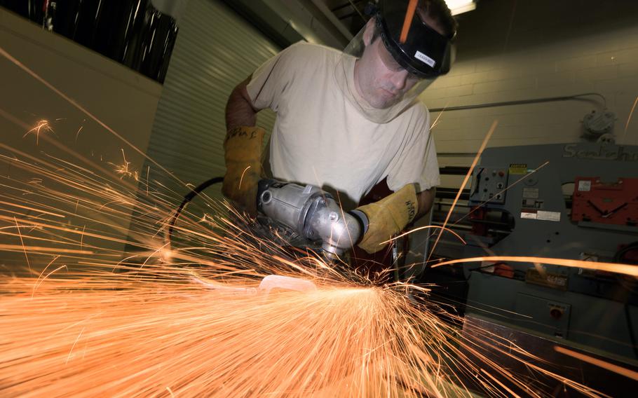 Master Sgt. Jim Vlacich, a machinist with the 106th Rescue Wing Metal Technologies shop, grinds down a section of metal at Francis S. Grabeski Air National Guard Base, N.Y., on Thursday, Aug. 6, 2015.