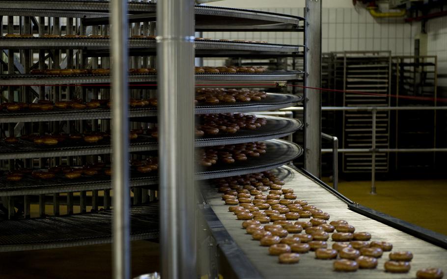 Krispy Kreme doughnuts dry before being boxed at the Exchange Bakery Europe in Gruenstadt, Germany, on Monday, Nov. 9, 2015. Thousands of doughnuts will be baked each week, and distributed to exchange stores across Europe.