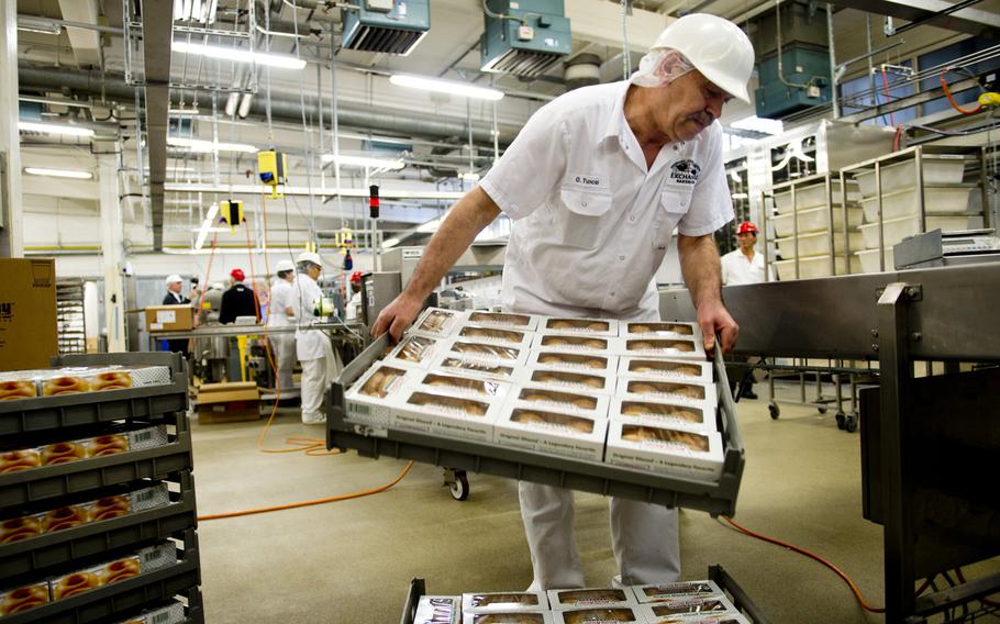 Omer Tuncel stacks trays of Krispy Kreme doughnuts that are ready for delivery at the Exchange Bakery Europe in Gruenstadt, Germany, on Monday, Nov. 9, 2015. This is the first time AAFES has made a deal with Krispy Kreme to sell its doughnuts in Europe.