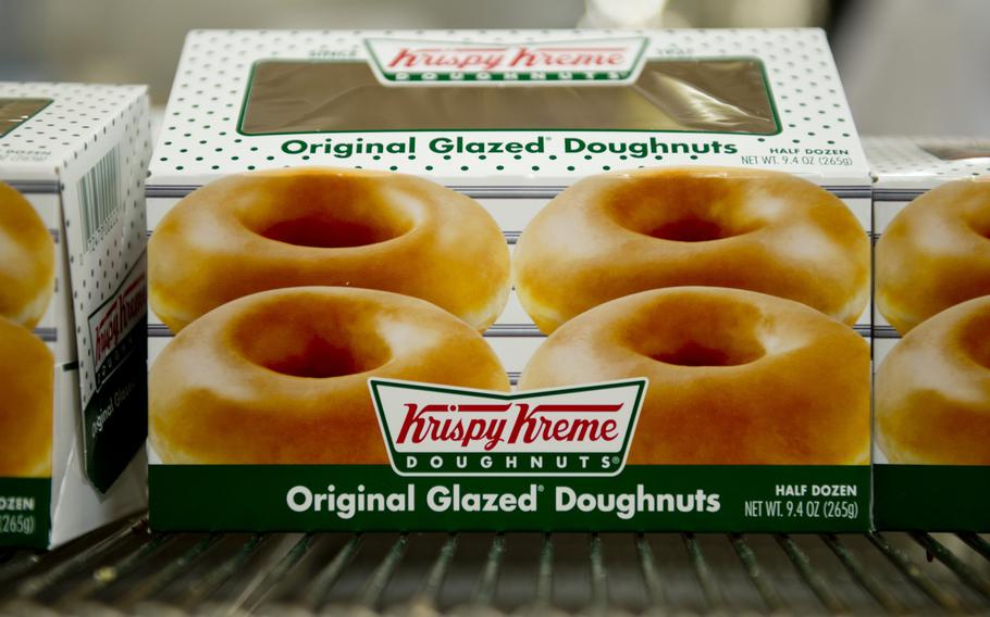 Boxes of Krispy Kreme doughnuts that are ready for delivery sit on the conveyor belt at the Exchange Bakery Europe in Gruenstadt, Germany, on Monday, Nov. 9, 2015. Thousands of doughnuts will be baked each week and distributed to exchange stores across Europe.