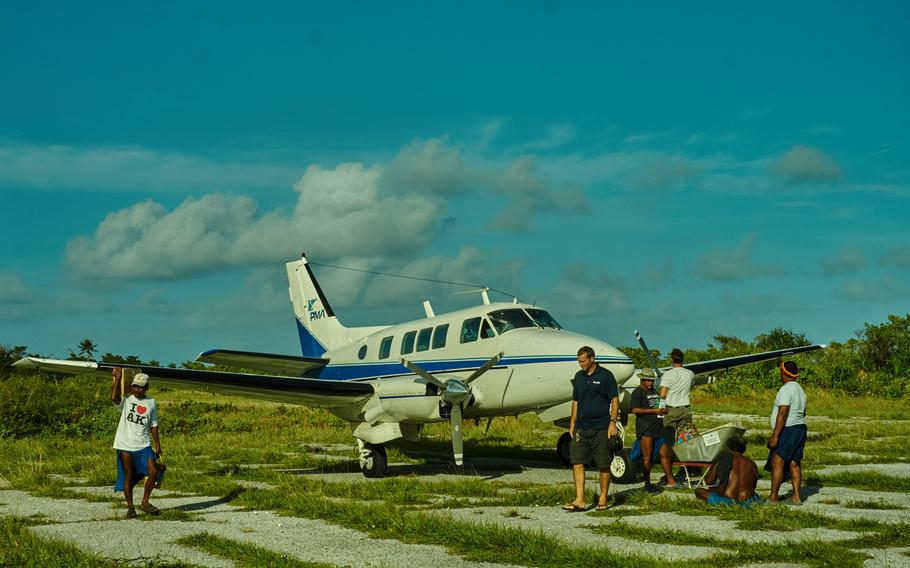 A charter flight flown by Pacific Mission Aviation debarks passengers and cargo at Fais Airfield on the remote atoll in the Federated States of Micronesia, Dec. 8, 2015.