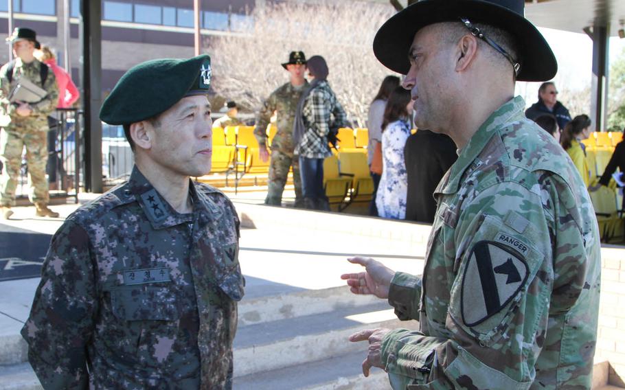 Col. John DiGiambattista, right, 1st Armored Brigade Combat Team, 1st Cavalry Division commander, discusses the brigade's nine-month rotation to South Korea with Maj. Gen. Kyoung Soo Shin, South Korea's defense attache to the United States, after a colors casing ceremony on Cooper Field at Fort Hood, Texas, Jan 28, 2016. Ironhorse soldiers will participate in several joint and multinational exercises with South Korean forces, and work with Korean augmentees to the United States.