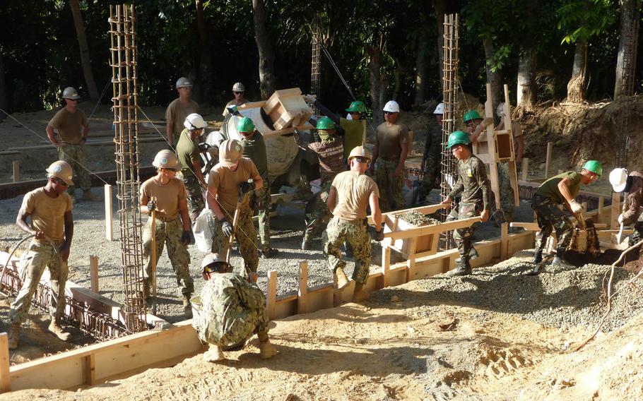 Seabees assigned to Naval Mobile Construction Battalion 3 build a school in Cebu, Philippines, in January. The fighting construction force is getting a new logo for its 75th anniversary next year.