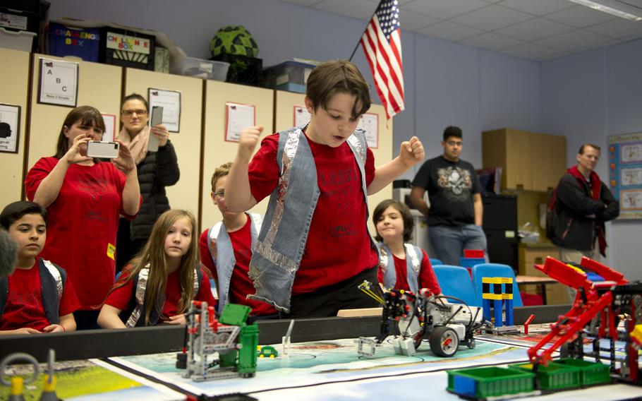 Mordecai Kenemore, a fifth-grade student at Kaiserslautern Elementary School, celebrates after his team's robot successfully completes a maneuver during a DODEA-Europe robotics competition for 10- to 14-year-old students in Kaiserslautern, Germany, on Monday, March 28, 2016.