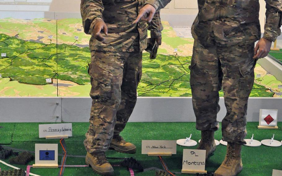 A pair of officers from the 173rd Airborne Brigade discuss a particular area of the map during a rehearsal briefing for exercise Saber Junction on Saturday, April 9, 2016, at Aviano Air Base, Italy.