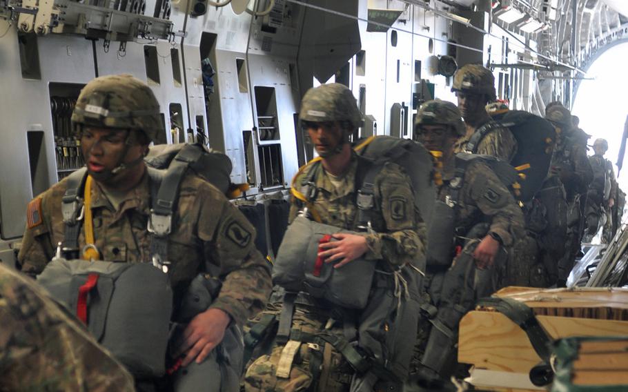 Soldiers from the 173rd Airborne Brigade, loaded down with gear, board a C-17 at Aviano Air Base, Italy, on Monday, April 11, 2016, as part of  exercise Saber Junction.