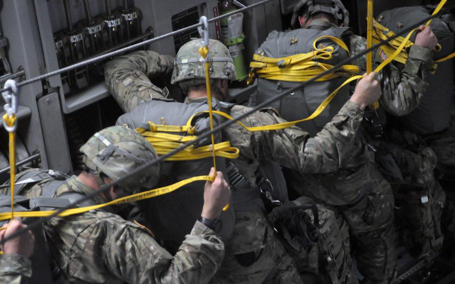 Soldiers from the 173rd Airborne Brigade participating in exercise Saber Junction wait their turns to jump from a C-17 over the skies of Hohenfels, Germany, on Monday, April 11, 2016.