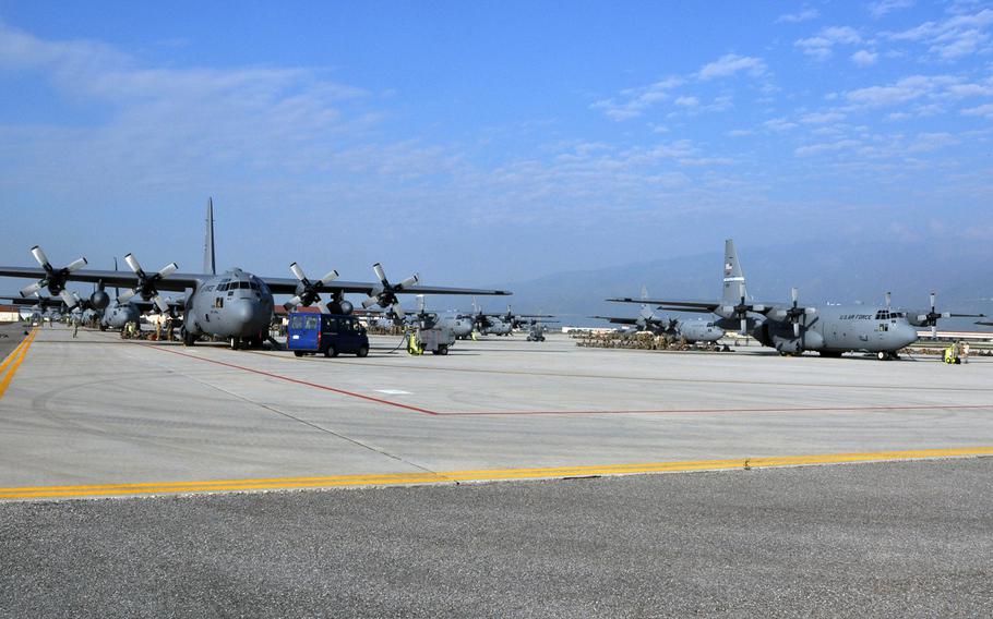 A dozen C-130 transport planes - 11 from U.S. bases and one from the United Kingdom - are parked along the south ramp at Avaino Air Base, Italy, on Tuesday, April 12, 2016, waiting to get loaded with airborne troops for a drop over Germany as part of exercise Saber Junction .