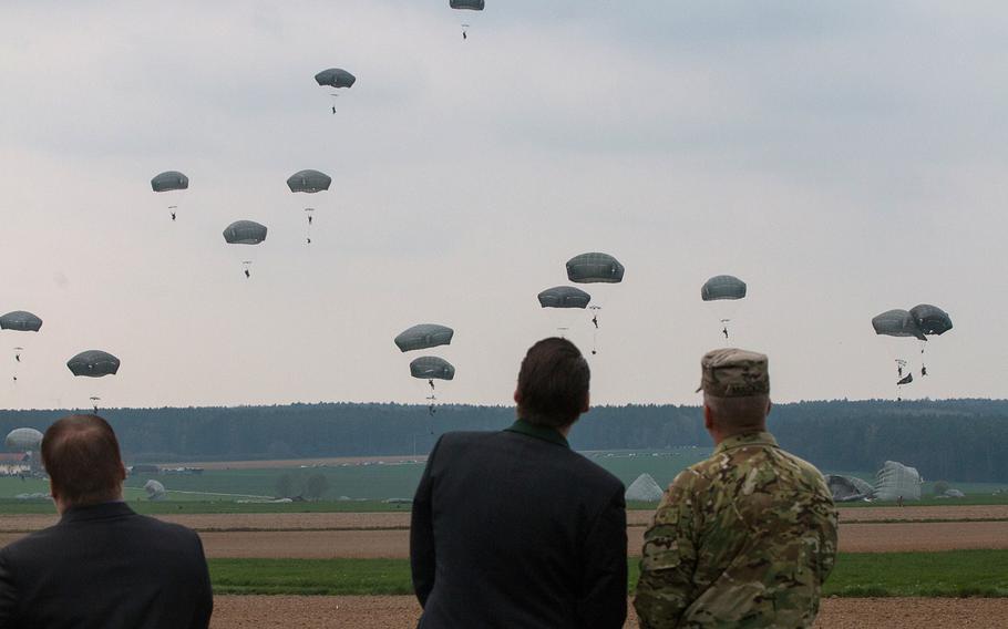 U.S. Army Col. Thomas Mackey, right, the Joint Multinational Readiness Center operations group commander, watches as paratroopers drop into Hoechensee, Germany, on Tuesday, April 12, 2016.