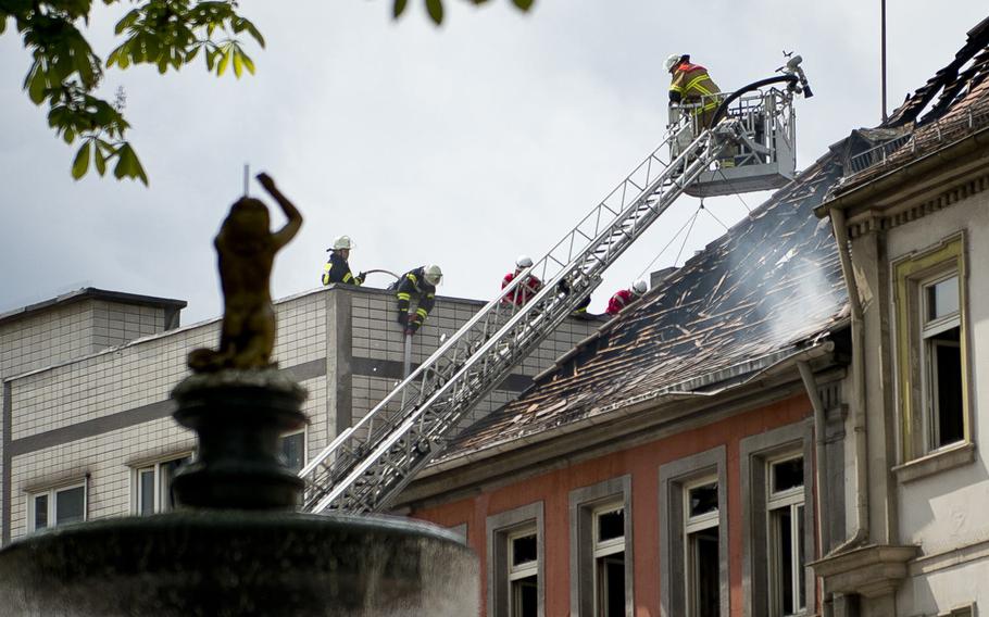 Firefighters work to completely extinguish a fire at the Hannenfass restaurant in Kaiserslautern, Germany, on Tuesday, May 3, 2016.