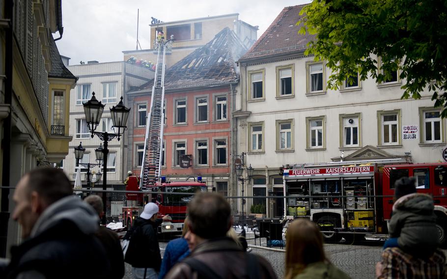 A crowd watches as fire-fighting operations continue at the Hannenfass restaurant in Kaiserslautern, Germany, on Tuesday, May 3, 2016. The restaurant caught fire early in the morning due to an unknown cause.