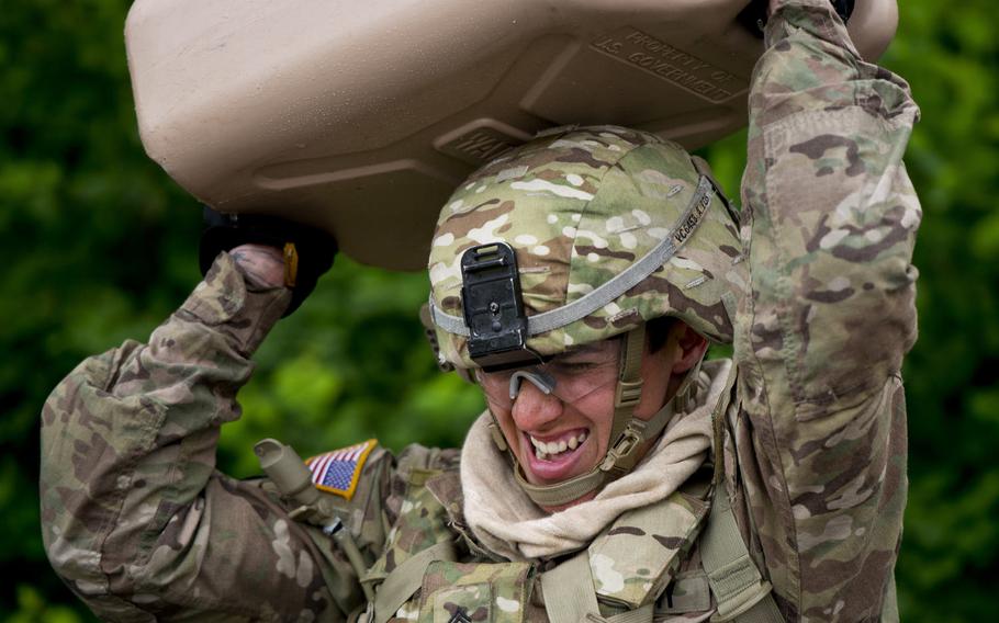 Sgt. Vanessa Carrillo from the 16th Sustainment Brigade overhead presses a 5-gallon jug of water during the 21st Theater Sustainment Command Best Warrior Competition in Baumholder, Germany, on Monday, May 23, 2016.