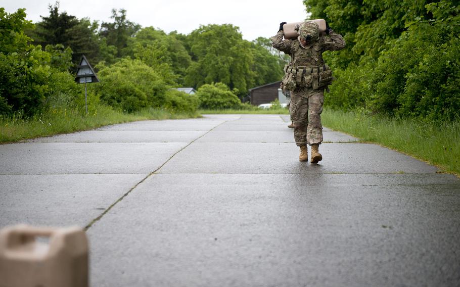 Sgt. Vanessa Carrillo carries a 5-gallon jug of water during the 21st Theater Sustainment Command Best Warrior Competition in Baumholder, Germany, on Monday, May 23, 2016.