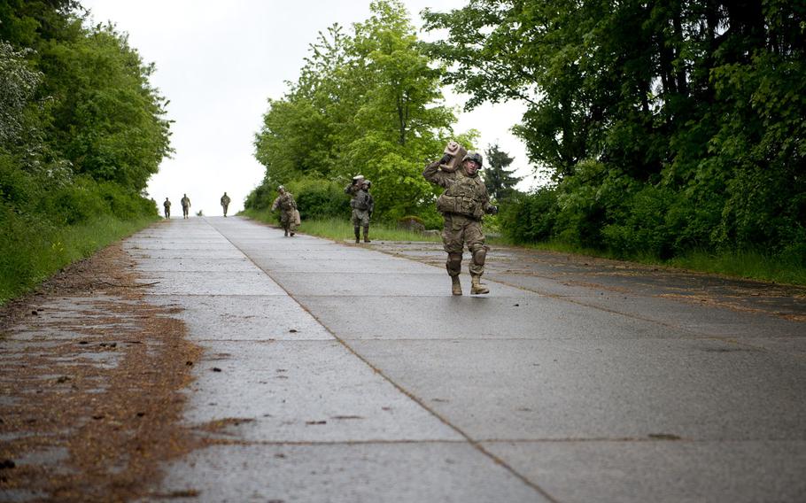 Competitors carry 5-gallon jugs of water during the 21st Theater Sustainment Command Best Warrior Competition in Baumholder, Germany, on Monday, May 23, 2016.