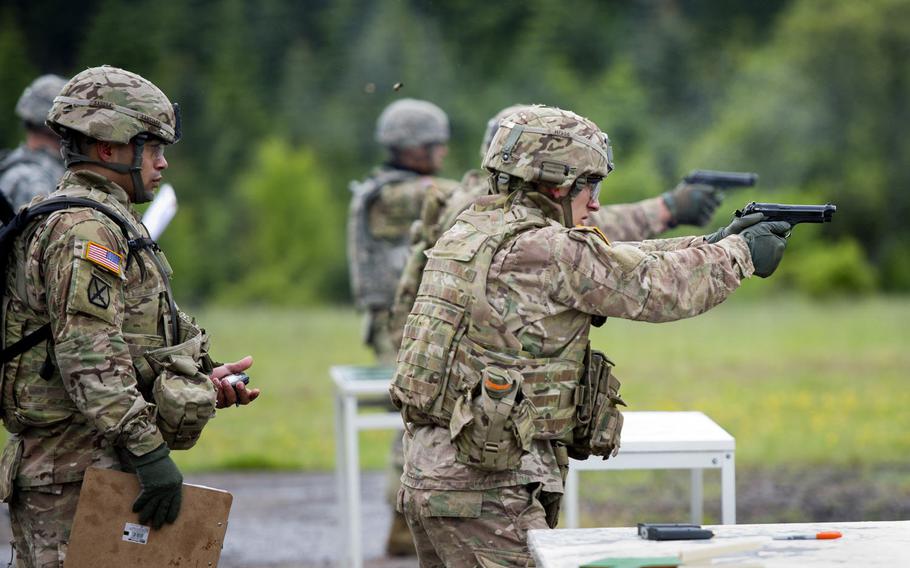 Sgt. Timothy Harris fires at a target after a series of physical challenges as part of the the 21st Theater Sustainment Command Best Warrior Competition in Baumholder, Germany, on Monday, May 23, 2016.