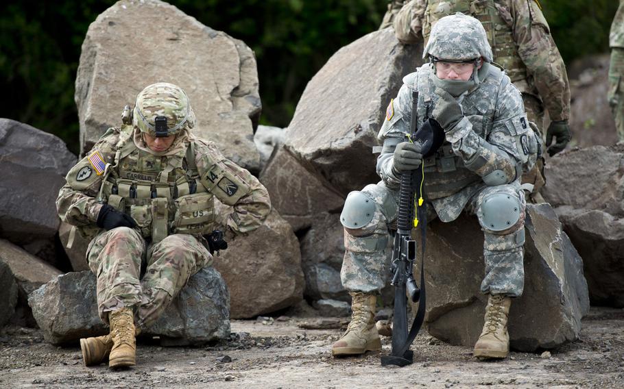 Sgt. Vanessa Carrillo, left, and Pfc. Joshua Parkinson take a break during the 21st Theater Sustainment Command Best Warrior Competition in Baumholder, Germany, on Monday, May 23, 2016. Carrillo and Parkinson are from the 16th Sustainment Brigade.