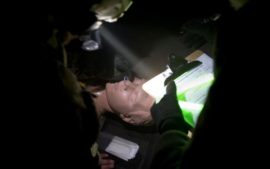 Sgt. Timothy Harris performs first aid on a simulated casualty during the 21st Theater Sustainment Command Best Warrior Competition in Baumholder, Germany, May 23, 2016.