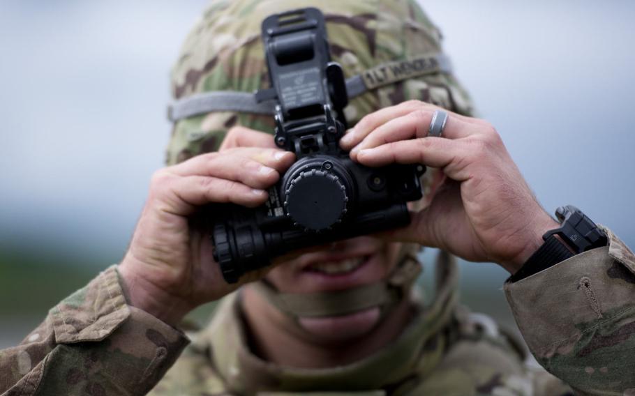 First Lt. Cody Wendelin from the 18th Military Police Brigade adjusts a set of night-vision goggles during the 21st Theater Sustainment Command Best Warrior Competition in Baumholder, Germany, on Monday, May 23, 2016.