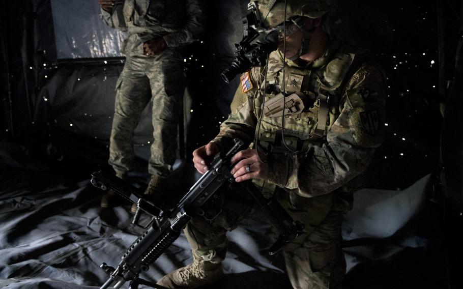 Sgt. Timothy Harris reassembles an M249 Squad Automatic Weapon wearing night-vision goggles during the 21st Theater Sustainment Command Best Warrior Competition in Baumholder, Germany, on Monday, May 23, 2016.