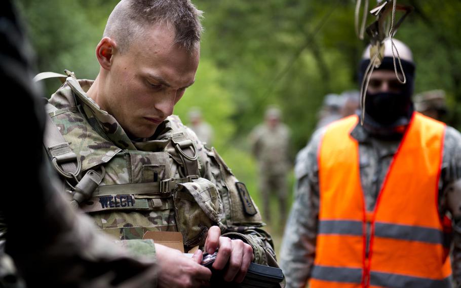 First Lt. Collin Welch from the 30th Medical Brigade loads paint-tipped ammunition into an M4 magazine during the 21st Theater Sustainment Command Best Warrior Competition in Baumholder, Germany, on Monday, May 23, 2016.