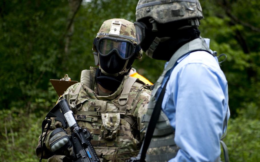 First Lt. Collin Welch speaks with a simulated militia member during the 21st Theater Sustainment Command Best Warrior Competition in Baumholder, Germany, on Monday, May 23, 2016.