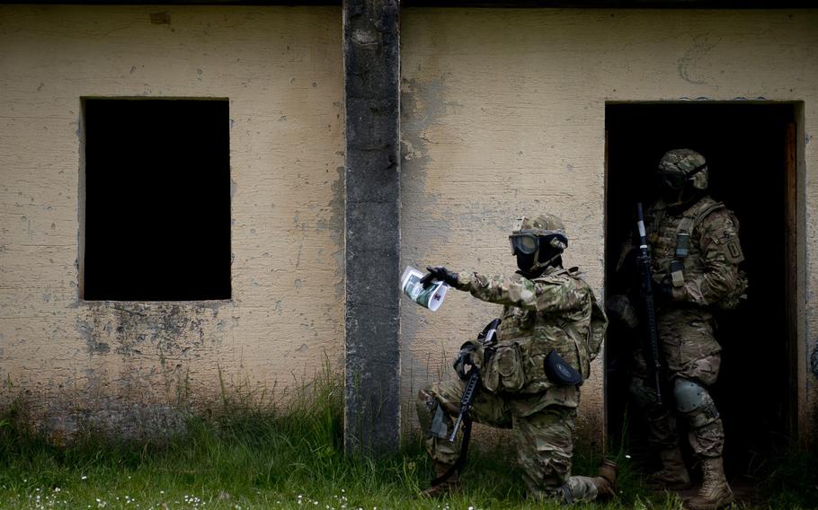 First Lt. Collin Welch, left, points out a simulated casualty to Spc. Kevin Luquis during a situational training exercise as part of the 21st Theater Sustainment Command Best Warrior Competition in Baumholder, Germany, on Monday, May 23, 2016. Welch and Collins are from the 30th Medical Brigade.