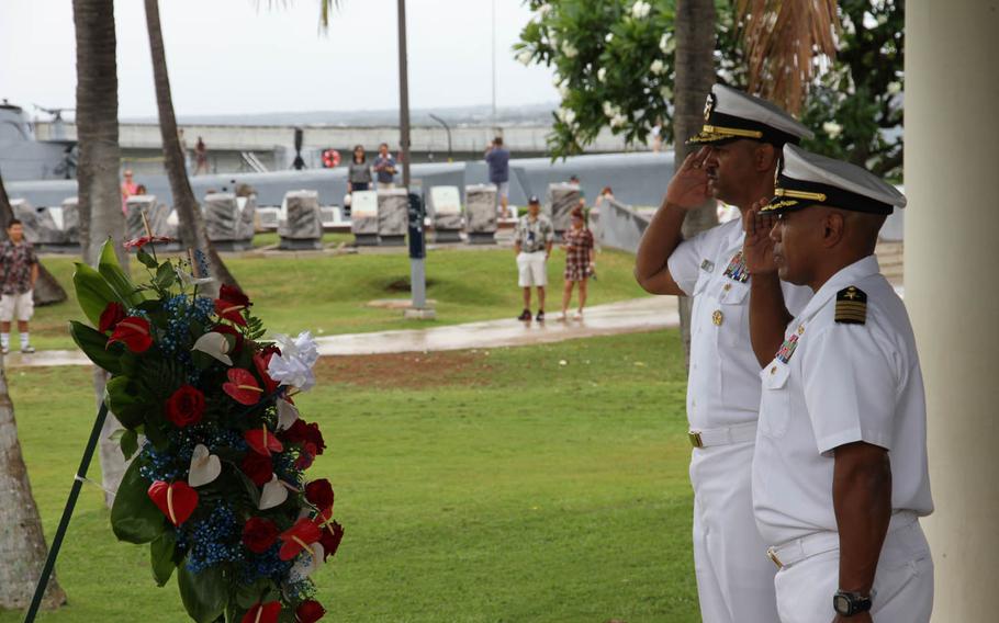 Capt. Stanley Keeve, commander of Joint Base Pearl Harbor-Hickam, foreground, and Rear Adm. John Fuller, commander of Navy Region Hawaii, salute during a moment of silence for the 1942 Battle of Midway, Tuesday, May 31, 2016.