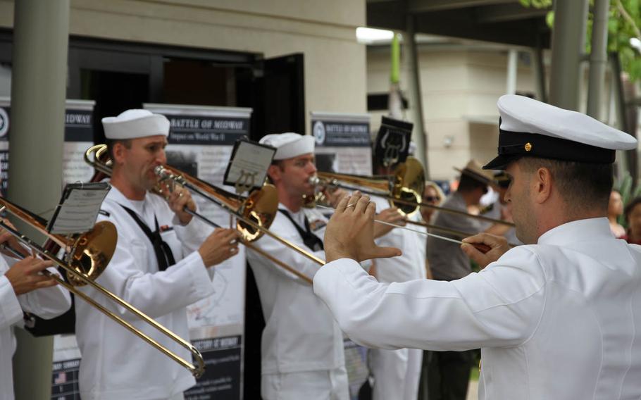 The Pacific Fleet Band plays a prelude to a ceremony in remembrance of the 1942 Battle of Midway, at Pearl Harbor Visitors Center in Honolulu, Tuesday, May 31, 2016.