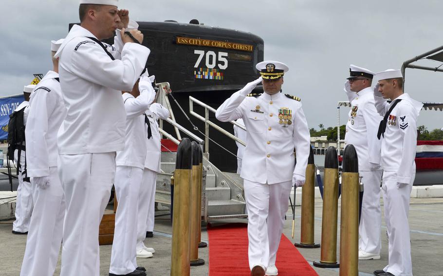 Cmdr. Travis M. Petzoldt, commanding officer of the Los Angeles-class fast-attack submarine USS City of Corpus Christi, is piped ashore at the conclusion of the vessel's Memorial Day decommissioning ceremony at Joint Base Pearl Harbor-Hickam, Monday, May 30, 2016. City of Corpus Christi concluded more than three decades of service as the second U.S. warship to be named after Corpus Christi, Texas.