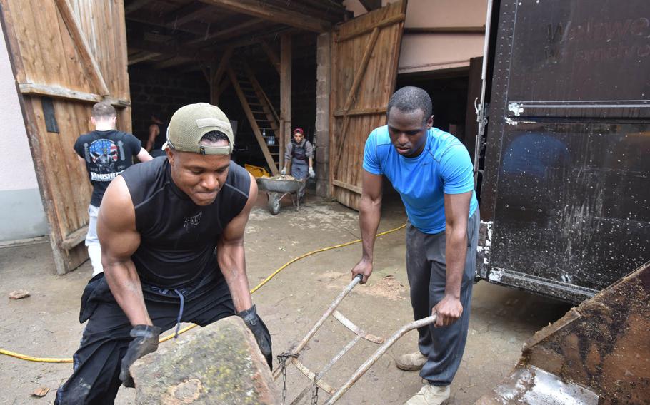First Sgt. Camron Emmanuel, left, and Spc. William Thurmond, both with 5th Detachment, 603rd Aviation Support Battalion, 12th Combat Aviation Brigade, work to repair flood damage in Markt Obernzenn, Germany, on Wednesday, June 1, 2016. More than 30 soldiers from the detachment volunteered to answer a call for aid from the town's mayor after heavy flooding in the area.