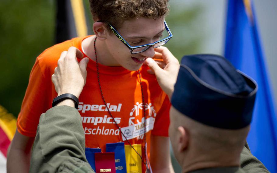 Wiesbaden High School's Conrad Grow receives a medal from Col. Mike Webb, 603rd Air Operations Center commander, during the Spring Special Olympics award ceremony at Ramstein Air Base, Germany, on Friday, June 3, 2016. 

Michael B. Keller/Stars and Stripes