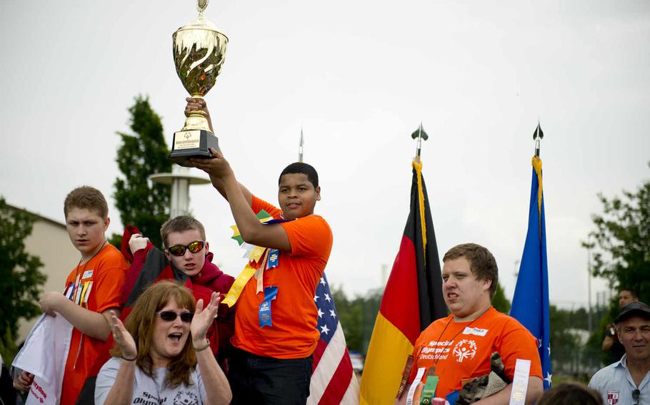 The Kaiserslautern High School team display the traveling trophy they won during the Spring Special Olympics award ceremony at Ramstein Air Base, Germany, on Friday, June 3, 2016. 