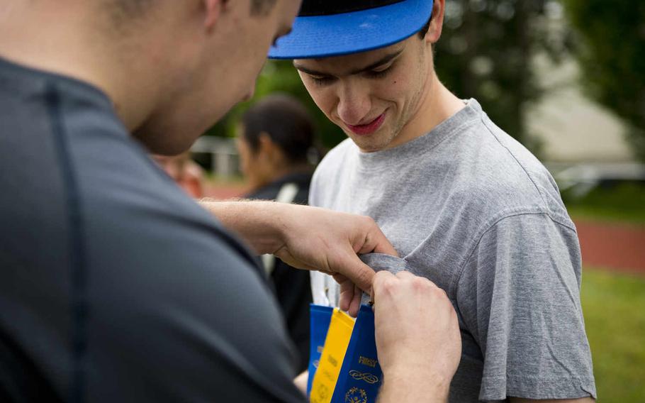 Wiesbaden High School's Woodrow Zorica receives a first-place ribbon for the football throw event during the Spring Special Olympics at Ramstein Air Base, Germany, on Friday, June 3, 2016. 

Michael B. Keller/Stars and Stripes
