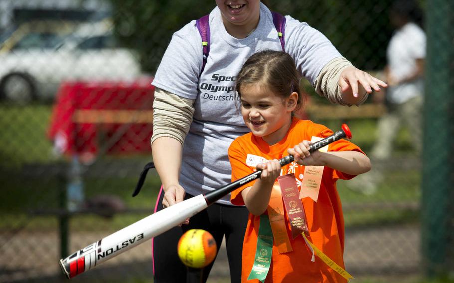 Vogelweh Elementary's Audrey Hanley, right, and her helper, Senior Airman Lisa Moristte, hit a tee ball during the Spring Special Olympics at Ramstein Air Base, Germany, on Friday, June 3, 2016. 

Michael B. Keller/Stars and Stripes