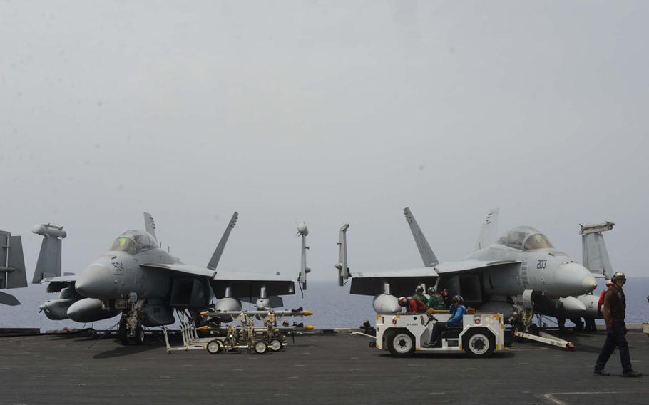 Two F/A-18 jets are prepared for launch on the USS Harry S. Truman on Friday, June 3, 2016. The Truman launched airstrikes against Islamic State targets in Syria and Iraq from the Mediterranean, a first in the nearly two-year long U.S.-led effort to defeat the militant group.