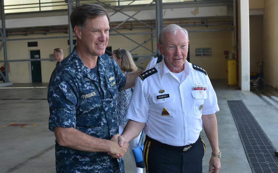 Adm. Mark Ferguson, left, commander of U.S. Naval Forces Europe-Africa, says goodbye to Gen. Martin Dempsey, chairman of the Joint Chiefs of Staff, following Dempsey's remarks to an audience of sailors at the Navy base in Naples, Italy, on June 11, 2015.  Ferguson handed over command on Tuesday, June 7,2016, to  Adm. Michelle Howard.