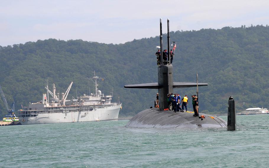 The Los Angeles-class fast-attack submarine USS Houston approaches the submarine tender USS Frank Cable in Malaysia in 2011. Houston will be decommissioned this year after more than 30 years of service.
