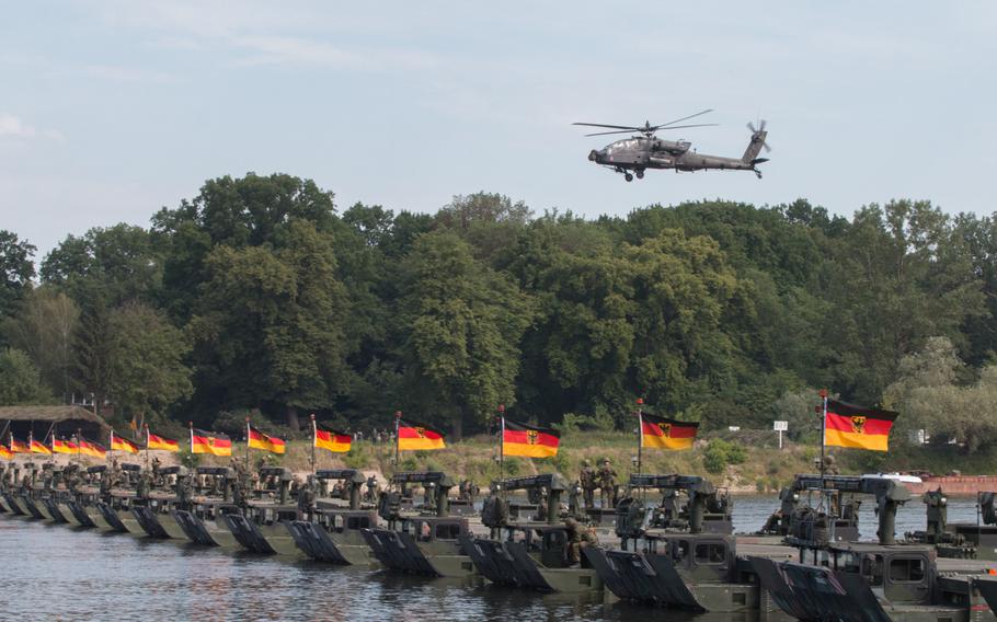An AH-64 Apache helicopter soars over a newly constructed bridge over the Vistula River near Torun, Poland, on Wednesday, June 8, 2016. A combined group of British and German soldiers conducted the hasty bridge assembly as part of the Anakonda multinational training event underway in Poland.