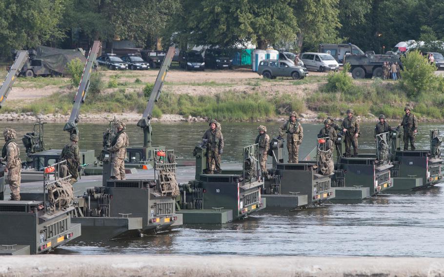 British and German soldiers on Wednesday, June 8, 2016, maneuver amphibious vehicles across the Vistula River in Chelmno, Poland, in order to assemble a bridge as part of joint training exercise Anakonda 16.