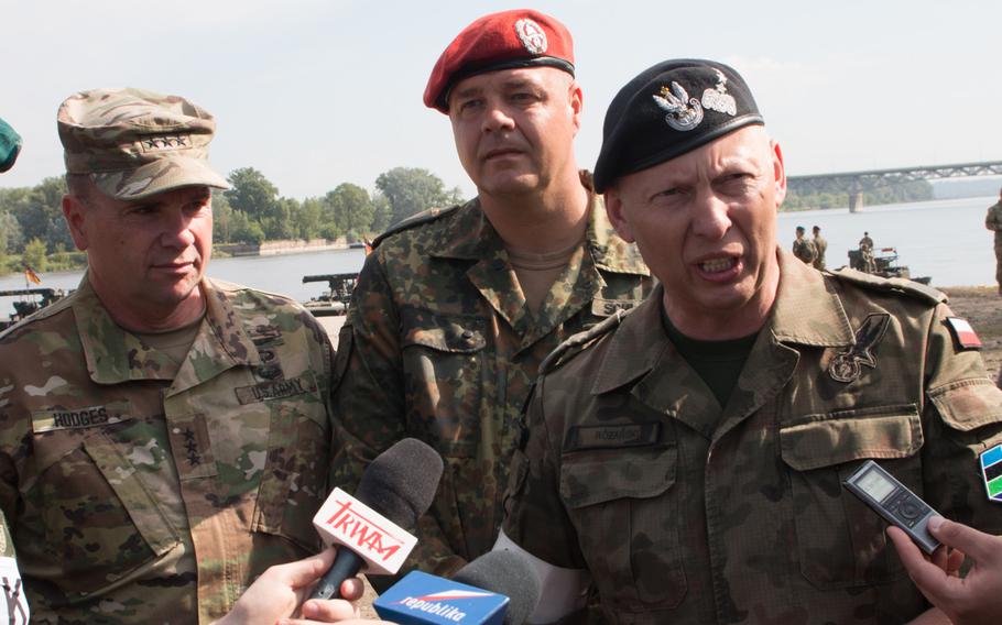 Polish Lt. Gen. Miroslaw Rozanski, left,  U.S. Army Europe commander Lt. Gen. Ben Hodges and German Lt. Col. Thorsten Schwiering field questions at the end of a hasty bridge assembly by German and British forces in Chelmno, Poland, on Wednesday, June 8, 2016.